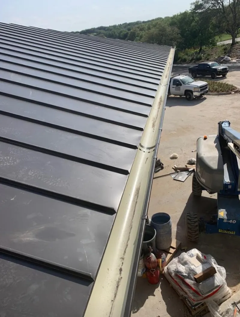Standing seam panel and gutter detail on a metal roofing jobsite in Marblehead